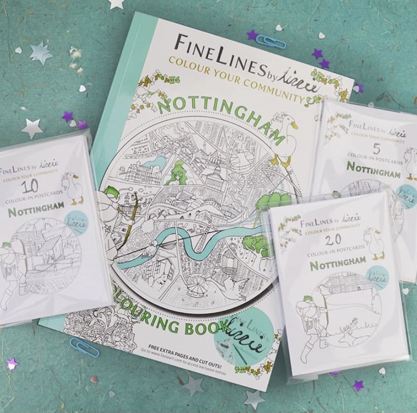 Colouring book and postcard packs laid on a starry background.