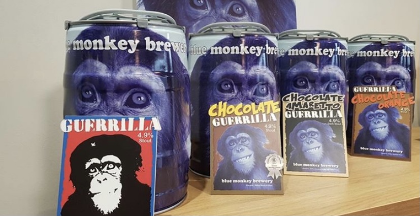 Mini kegs of beers with brightly coloured labels with chimpanzees on.