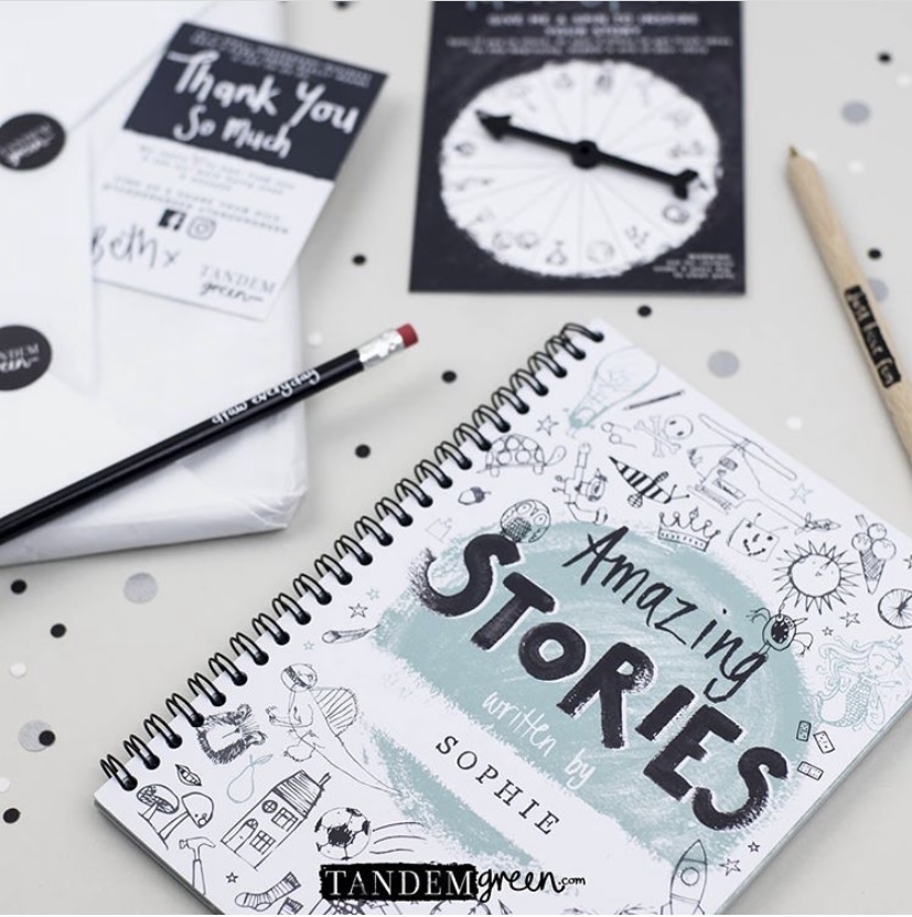 Stories book, spinner and stationery on a tabletop. 