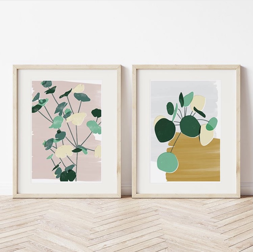 Two framed prints against a light coloured wall.